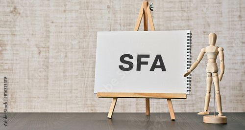 There is notebook with the word SFA. It is an abbreviation for Sales Force Automation as eye-catching image. photo