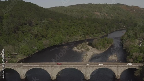 Aerial view of Dunkeld Bridge landmark with vehicles riding on street and River Tay scenery in Scotland, UK photo