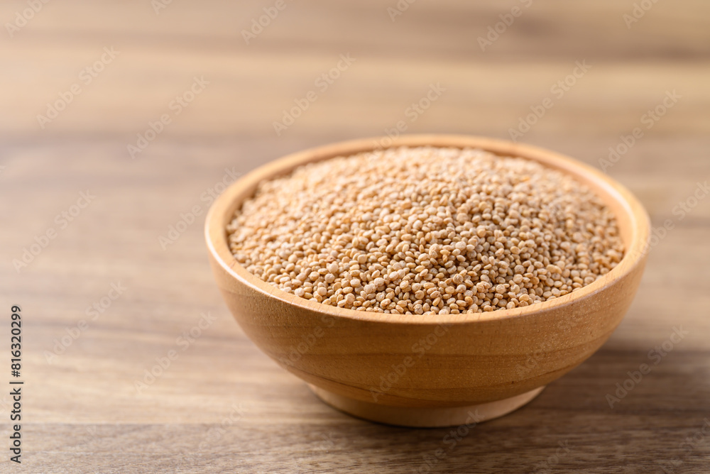 Brown quinoa seed in bowl on wooden background, Healthy food ingredient Brown quinoa seed in bowl on wooden background, Healthy food ingredient