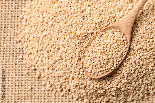 Brown quinoa seed in wooden spoon, Healthy food ingredient