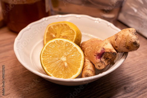 Lemon and ginger in a bowl, honey, healthy ingredients for a tea for cold and flu