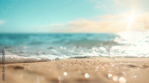 Close up shot of foaming sea wave and sand with beautiful blurred sunny beach background
