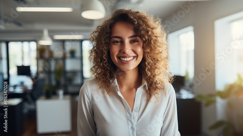 portrait of a young redhead woman smiling in the office  businesswoman looking at camera with a beautiful smile