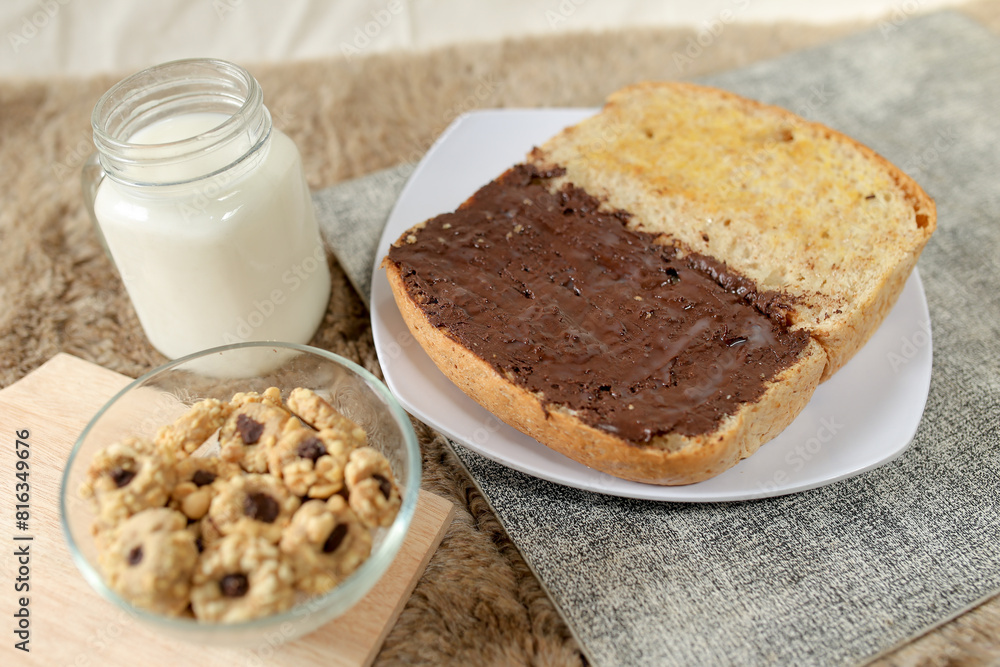 Bread with chocolate spread filling, milk and snack for breakfast Bread with chocolate spread filling, milk and snack for breakfast
