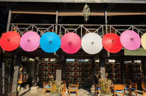 Mulberry paper umbrella that are hung over the road to decorate on the background of the bright sky in the Bo Sang umbrella festival that is the source of producing and selling mulberry paper umbrella photo