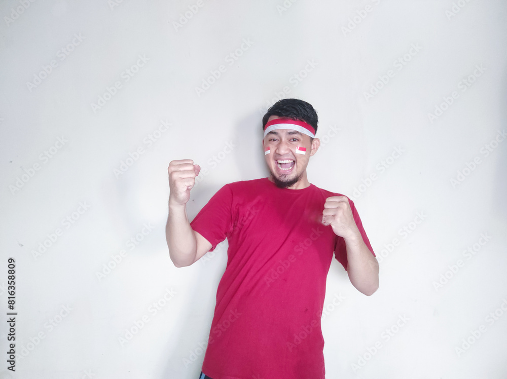 Indonesian man clenches fist with excited and happy expression on independence day