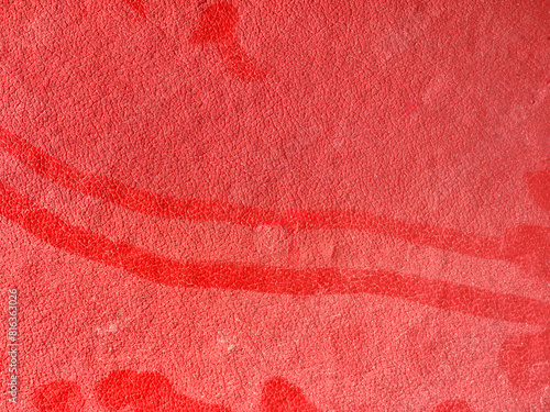 Red textured surface with dust close-up