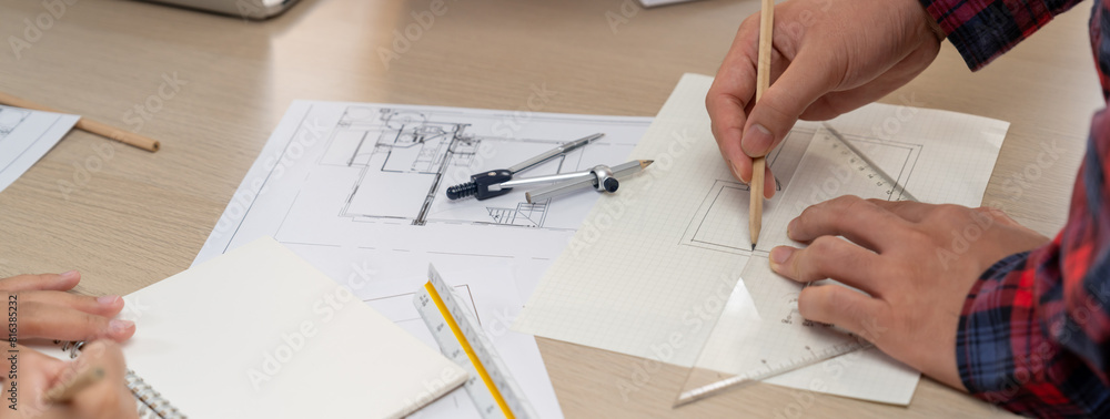 Professional architect hand drawing a blueprint by using ruler ...