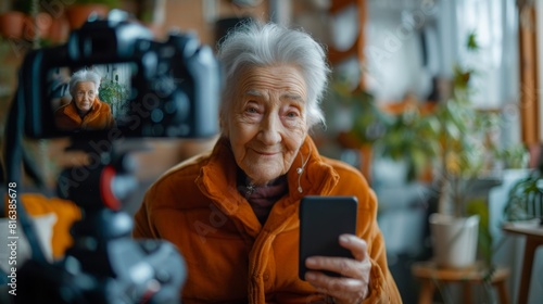 portrait of an elderly Caucasian woman 70 -79 years old sitting in front of the camera recording a blog. retired blogger gives an interview in front of the camera photo