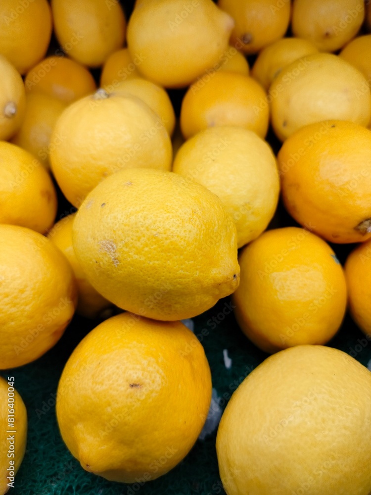 Lemon fruit. Stacked citrus fruits are sold at supermarkets. Sweet fruits are fresh and healthy. Lemon fruit. Stacked citrus fruits are sold at supermarkets. Sweet fruits are fresh and healthy.