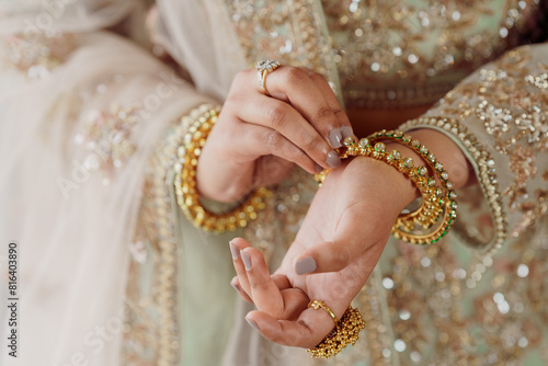 Indian, Pakistani Bride fixing the bangle closeup shot