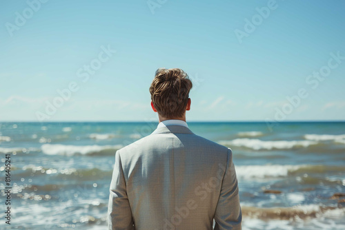 Groom on the beach, back view
