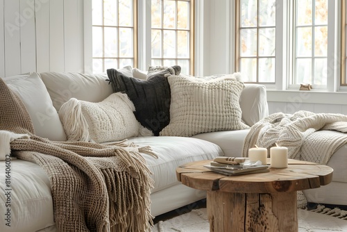 Cozy loveseat sofa near round accent coffee table. Scandinavian home interior design of modern living room in farmhouse. photo