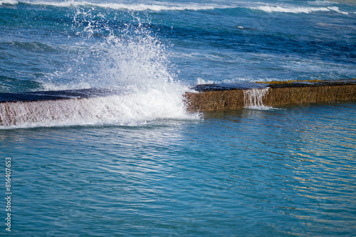 Ocean Wave Breaking Over a Sea Wall in Hawaii.