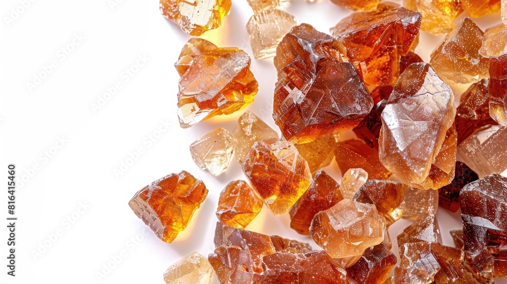 Amber Colored Mineral Stones Resembling Sugar on a White Background with Room for Text Amber Colored Mineral Stones Resembling Sugar on a White Background with Room for Text