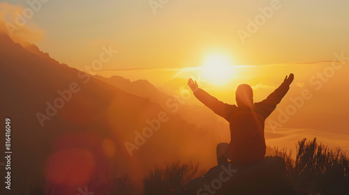 Silhouette of a person kneeling with open arms and looking at the sky on top of a mountain Concept of religious and spiritual life Warm atmosphere at dawn Copy space   Generative AI
