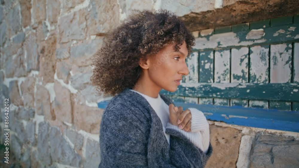 Sad woman posing castle wall windy weather day. Curly model feeling thoughtful Sad woman posing castle wall windy weather day. Curly model feeling thoughtful