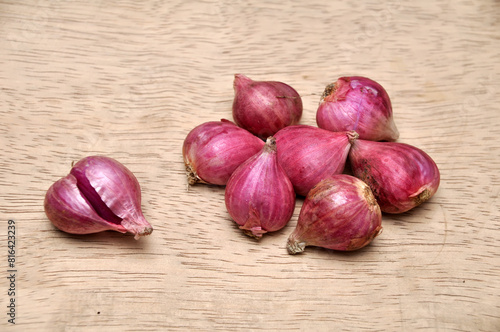 Onions on a wooden table in the kitchen photo