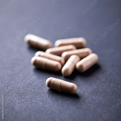Cat's Claw (Uncaria tomentosa) Extract Capsules. A Dietary Supplement. Immune System Support. Dark paper background. Close up. Copy space.
 photo