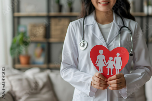 Female doctor holding a love paper representation of family health and care, copy space