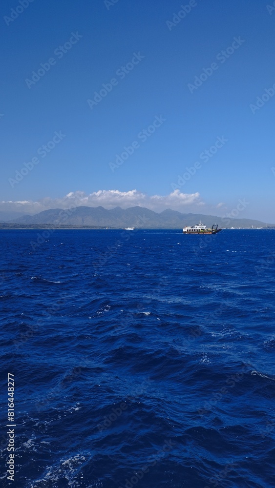 Bali Island : blue sea and sky with mountain as background