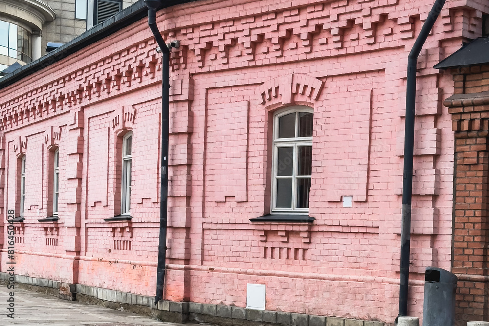 Fototapeta premium Brick pink facade of an ancient merchant building in Moscow.