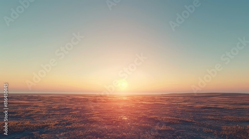 A vast expanse under the clear sky with the sun setting in the distance