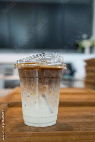 Close up view of iced latte coffee in plastic glass in the morning