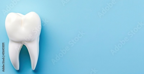 a close - up of a white tooth on a blue background  with a toothbrush and a toothpaste visible in the foreground