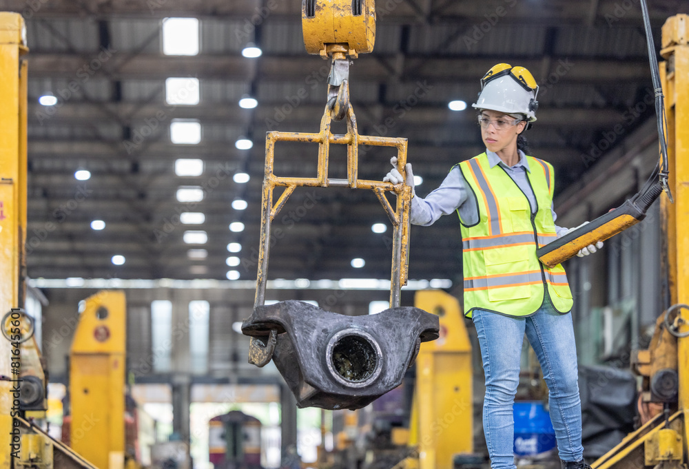 Maintenance engineer uses machine to lift and replace locomotive parts, reducing carbon emissions. Maintenance engineer uses machine to lift and replace locomotive parts, reducing carbon emissions.
