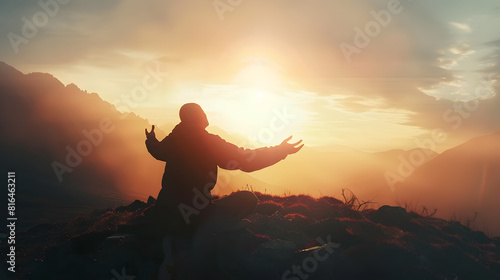 Silhouette of a person kneeling with open arms and looking at the sky on top of a mountain Concept of religious and spiritual life Warm atmosphere at dawn Copy space   Generative AI
