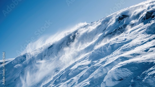 A substantial flow of melted snow cascades down the hill like a waterfall from its summit