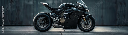 A black, sleek, highperformance motorcycle against a dark background photo