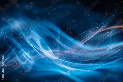 Long exposure photograph of dynamic blue light trails winding along a dark, curvy road, creating an ethereal nighttime scene. 