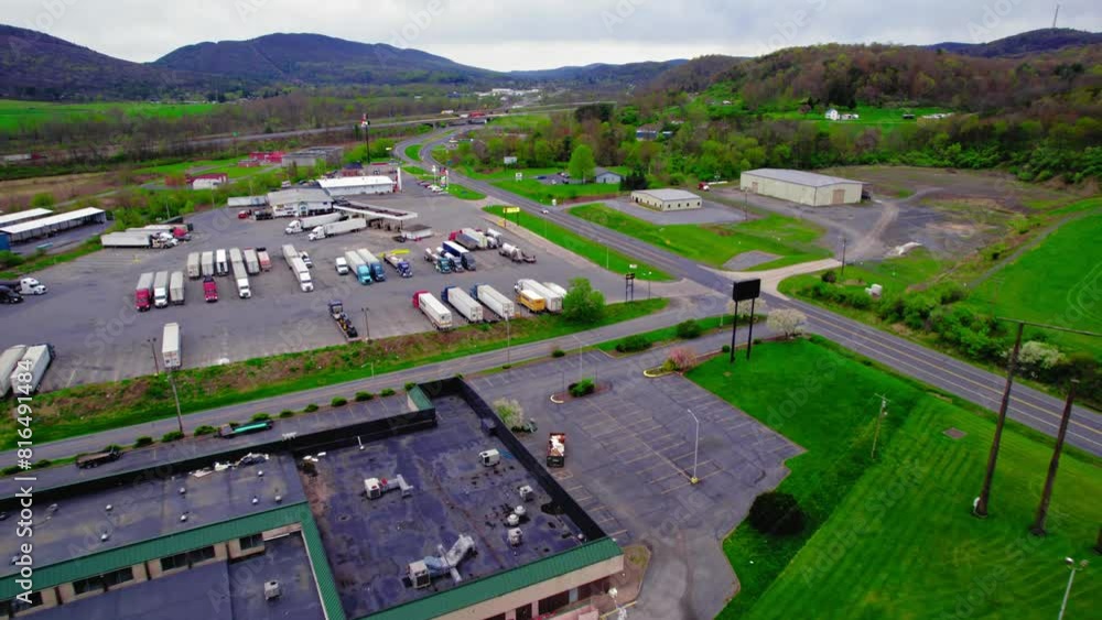 Aerial view of a busy truck stop in Milesburg, PA with semi trucks and trailers. Logistics and transportation hub concept. Aerial view of a busy truck stop in Milesburg, PA with semi trucks and trailers. Logistics and transportation hub concept.