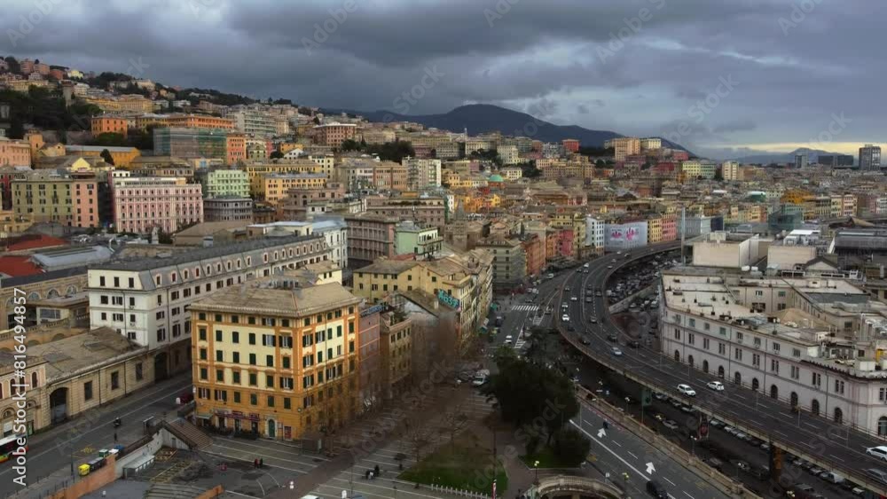 Genoa showing bustling city and port with dramatic cloudy skies, aerial view Genoa showing bustling city and port with dramatic cloudy skies, aerial view
