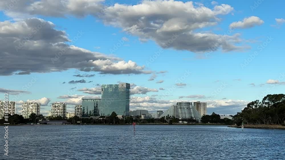 Medium shot across Swan River to Burswood Crown Casino Perth blue sky puffy clouds Medium shot across Swan River to Burswood Crown Casino Perth blue sky puffy clouds