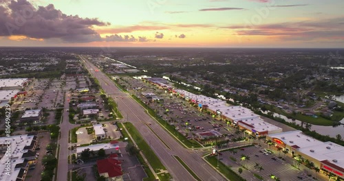 Aerial view of shopping plaza stores and American wide highway with many driving cars in North Port, Florida. photo