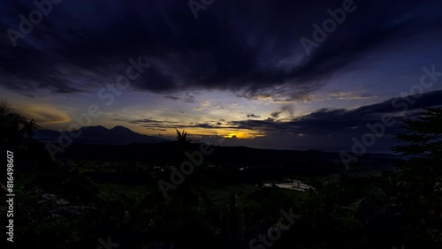 Scenic sunrise time lapse with cloud movement over lush Tenganan Bali landscape photo