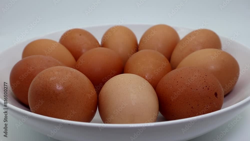 Fresh eggs in a bowl on turntable isolated on white background Fresh eggs in a bowl on turntable isolated on white background
