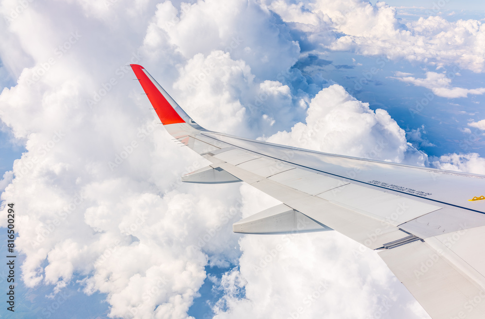 View from the airplane window at a beautiful cloudy sky and the airplane wing View from the airplane window at a beautiful cloudy sky and the airplane wing