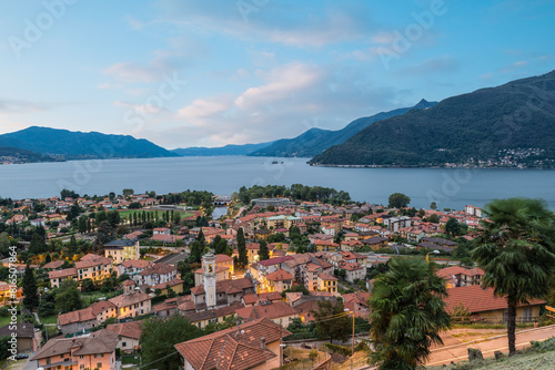 Large Italian lake at dawn. Maccagno city and Lake Maggiore seen from above with the Lombard side of the lake on the left, the Piedmont side on the right. Northern Italy