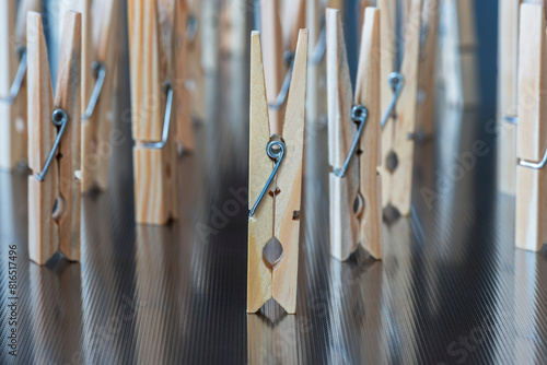 Set of wooden clothespins, standing on metal table, ready to use