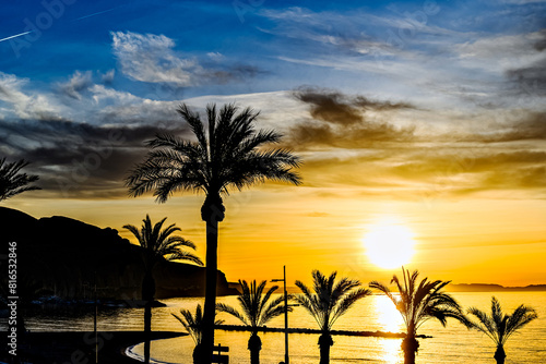 Beautiful sunset with orange sky on Aguadulce beach, Almeria, Andalucia	