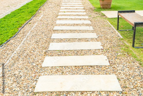 Marble walkway of square tiles in backyard of the mansion,Alley in tropical garden,Garden landscape design with pathway,Selective focus. © wanatithan