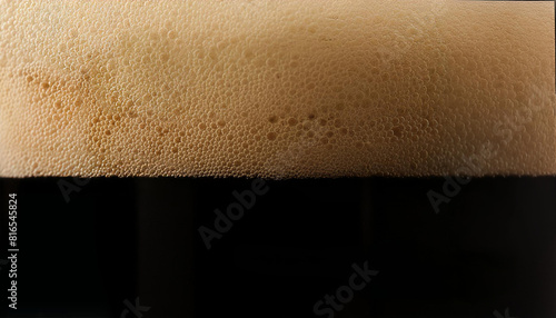 Closeup of stout beer with bubbles and foam in glass