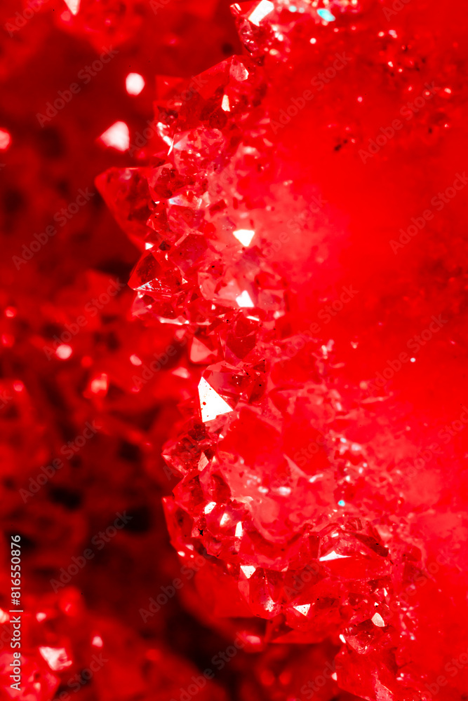 Amethyst red crystals. Gems. Mineral crystals in the natural environment. Texture of precious and semiprecious stones. Seamless background with copy space colored shiny surface of precious stones. Amethyst red crystals. Gems. Mineral crystals in the natural environment. Texture of precious and semiprecious stones. Seamless background with copy space colored shiny surface of precious stones.