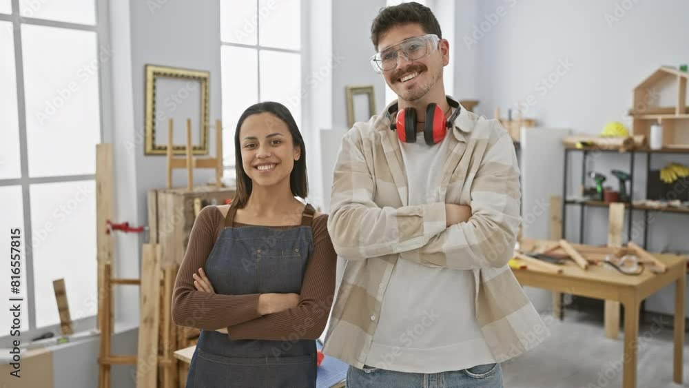 A woman and a man in a carpentry studio pose together, showcasing teamwork in a woodworking workspace. A woman and a man in a carpentry studio pose together, showcasing teamwork in a woodworking workspace.