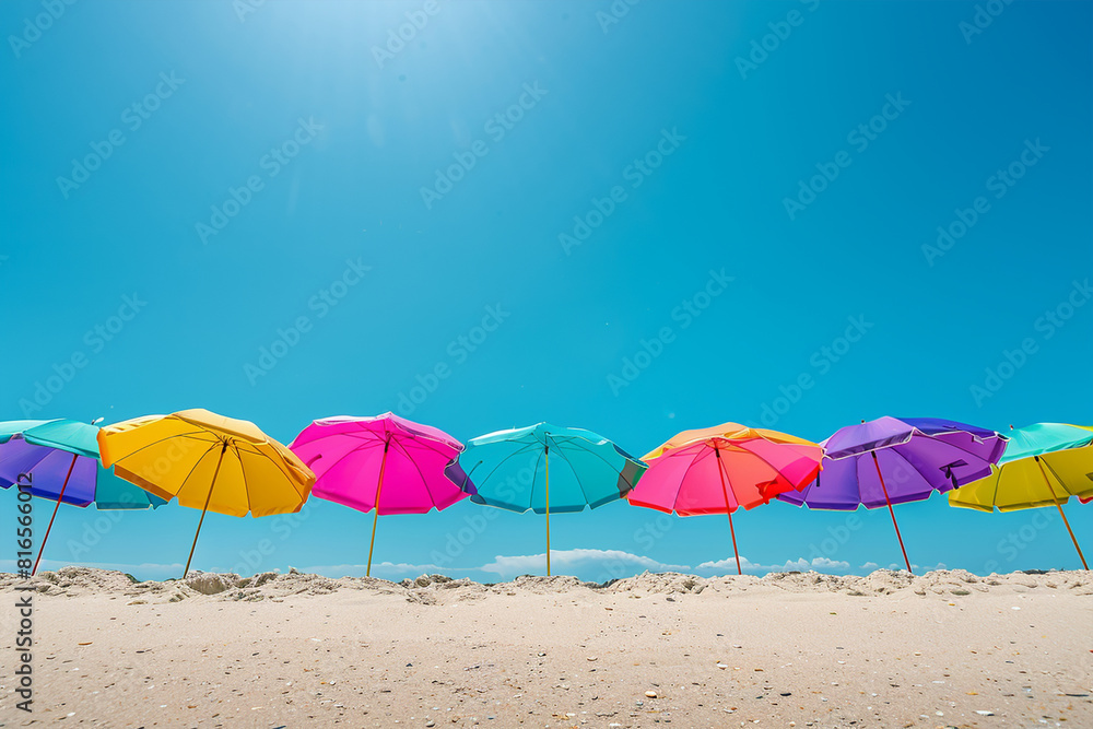 Vibrancy of summer with colorful beach umbrellas set against a clear blue sky. Vibrancy of summer with colorful beach umbrellas set against a clear blue sky.