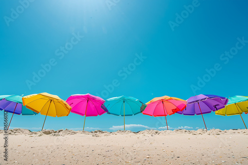 Vibrancy of summer with colorful beach umbrellas set against a clear blue sky.